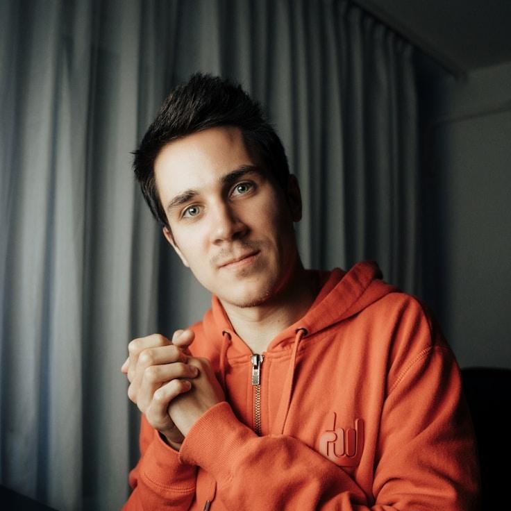 Avery Lin, Lead Design Curator at SeedScribeLakeside, reviewing corporate floral arrangements